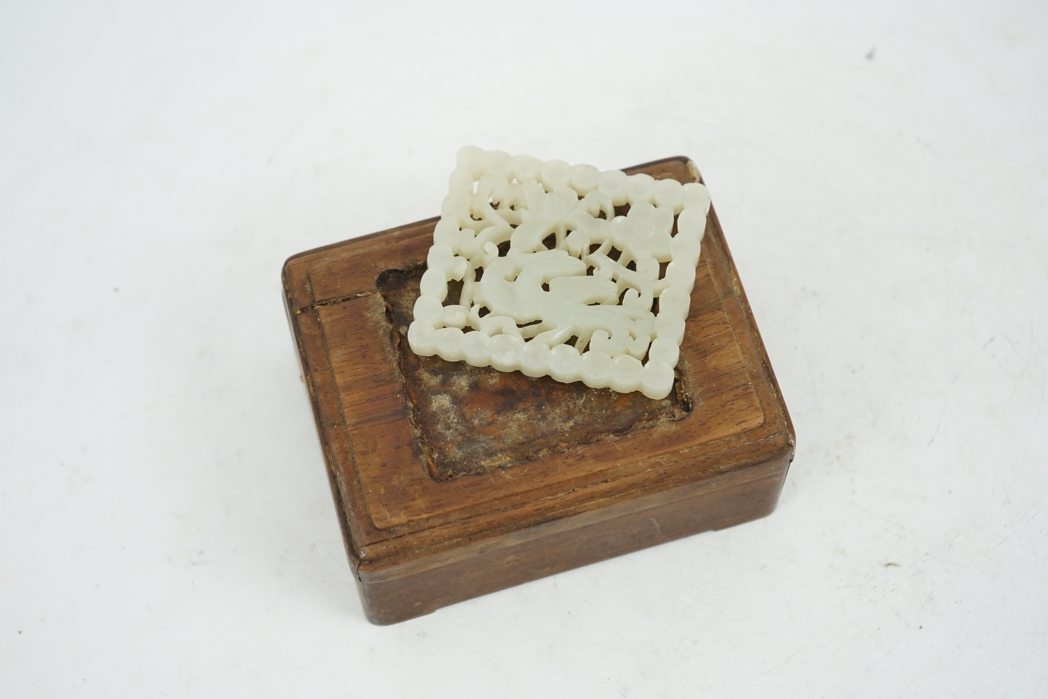 A Chinese pale celadon jade plaque, 17th/18th century, now inset into a hongmu box